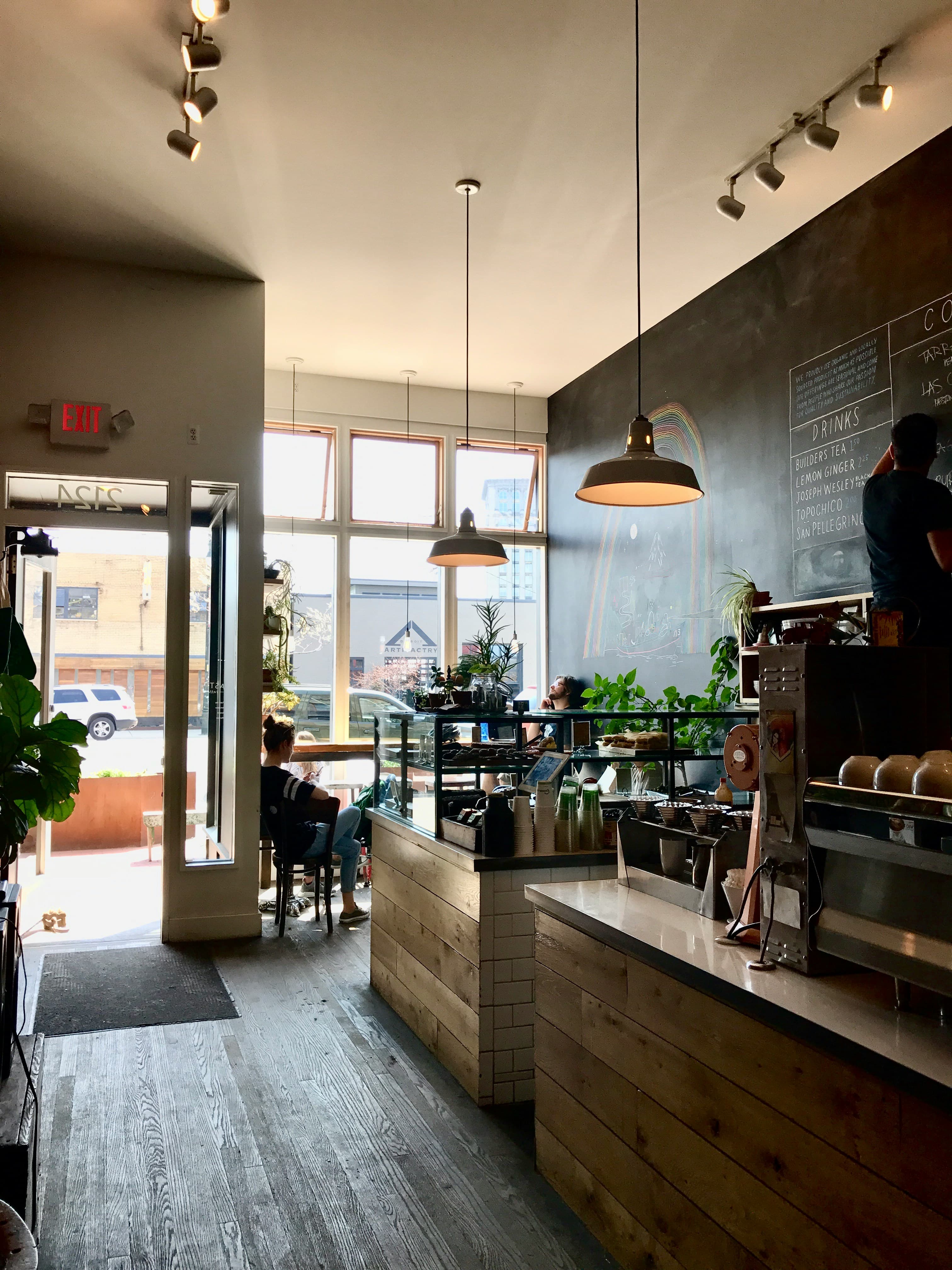 Sunlit interior of Baan Kaffe with a wooden coffee bar